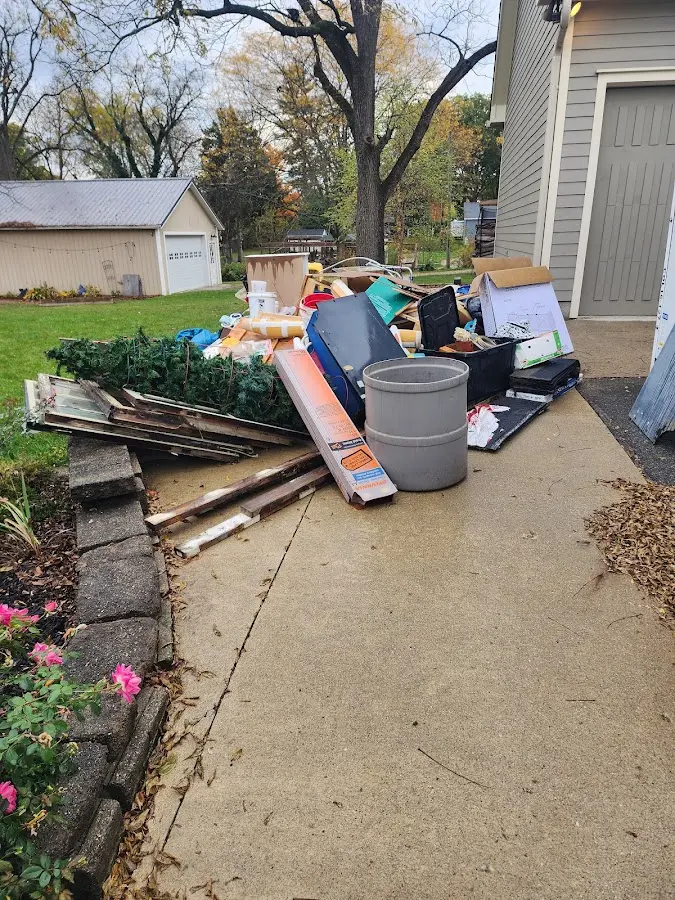 Dumpster being loaded with debris for Commercial Dumpster Rental in Lewiston